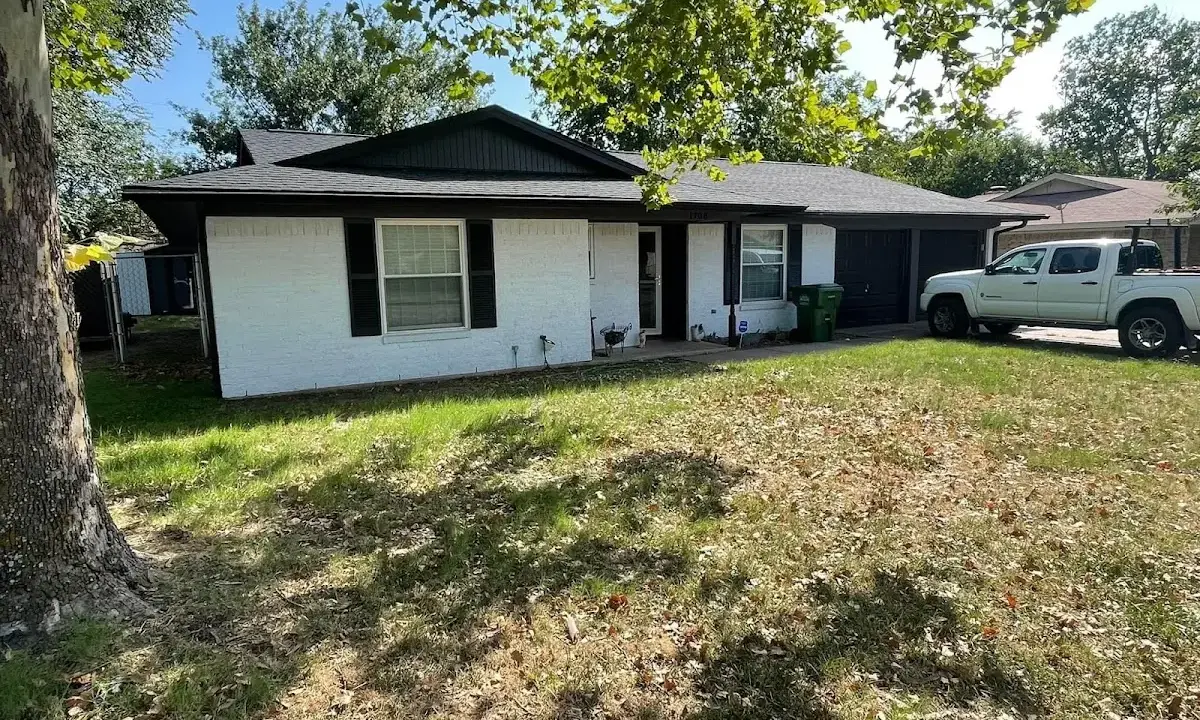 Professional roofing crew working on a residential roof in Island Park